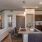 Spacious and well lit kitchen with wood floors and black appliances 