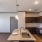 Spacious and well lit kitchen with wood floors and black appliances 